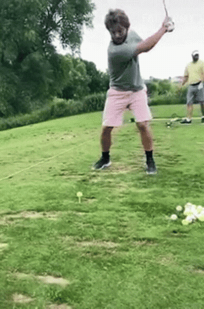 Man Swinging Golf Club In Pink Shorts GIF