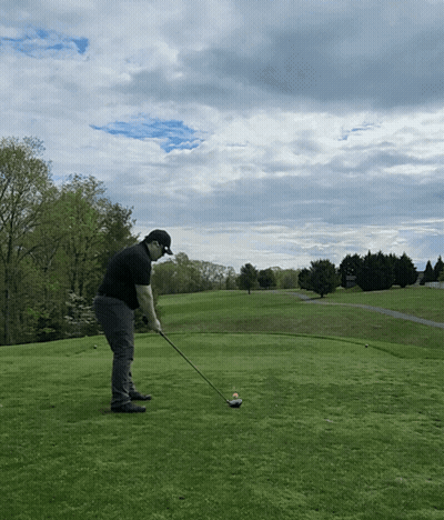 Man Swinging Golf Club On Green GIF