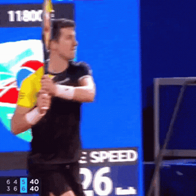 Man Swinging Tennis Racquet In Front Of Speed Board GIF