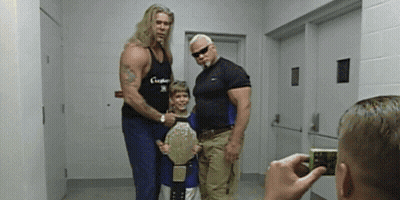 Man Taking Photo Of Wrestlers And Boy With Belt GIF