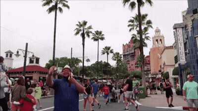 Man Taking Picture At Couture Store GIF