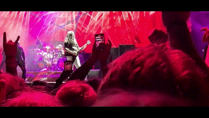 Man Taking Picture of Band on Stage