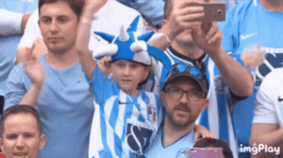 Man Taking Picture Of Boy In Horned Hat GIF