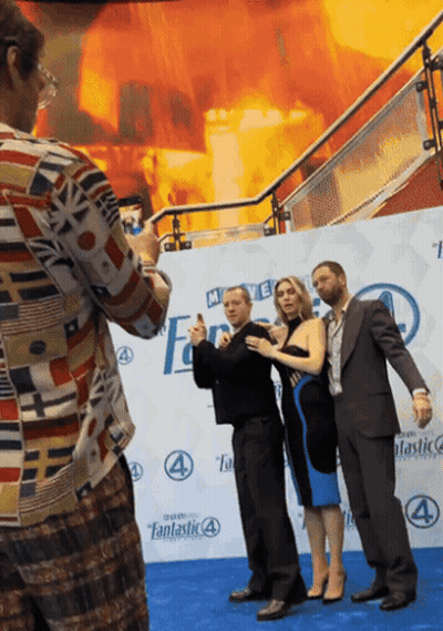 Man Taking Picture Of Group On Fantastic 4 Blue Carpet GIF