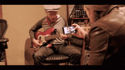 Man Taking Picture Of Guitarist GIF