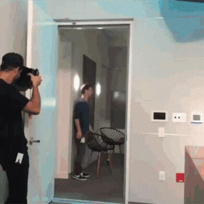 Man Taking Picture of Man Standing in Room