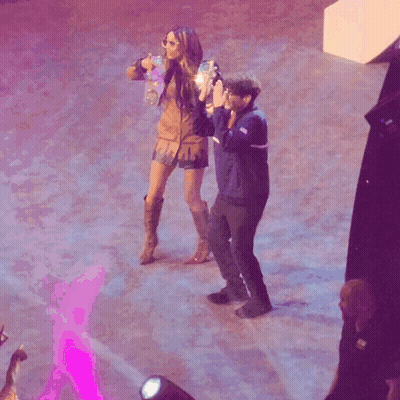 Man Taking Picture Of Woman Dancing On Stage GIF