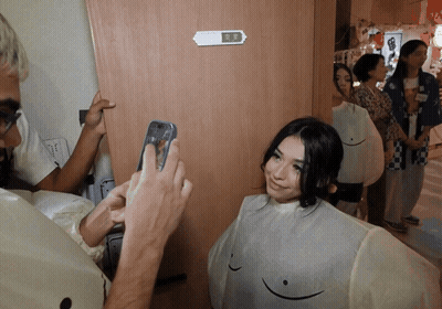 Man Taking Picture Of Woman With Smiley Face On Breasts GIF