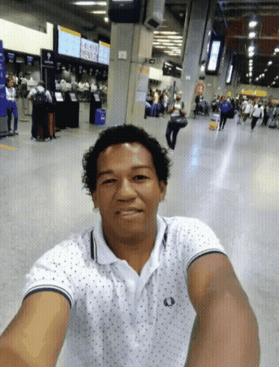 Man Taking Selfie At Airport With Aeroporto Sign GIF