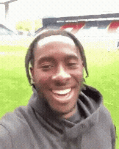 Man Taking Selfie in Front of Soccer Field