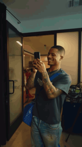 Man Taking Selfie In Mirror With Phone GIF