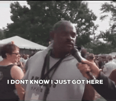 Man Talking Into Microphone In Crowd GIF