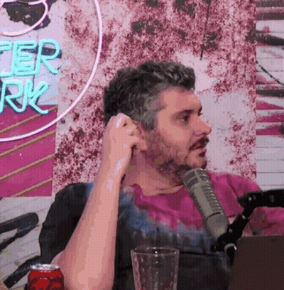 Man Talking Into Microphone In Front Of After Work Neon Sign GIF