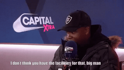 Man Talking Into Microphone In Front Of Capital Xtra Logo GIF