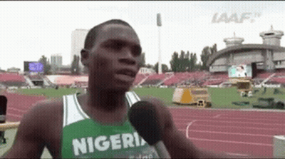Man Talking Into Microphone On Track In Nigerian Jersey GIF