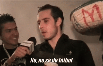 Man Talking Into Microphone While Another Watches GIF