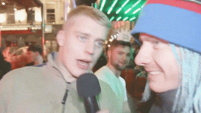 Man Talking Into Microphone With Blue And Red Hat GIF