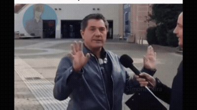 Man Talking Into Microphone With Simone Kira Poster GIF