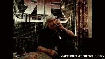 Man Talking On Cell Phone At Table With 21 Video Sign GIF