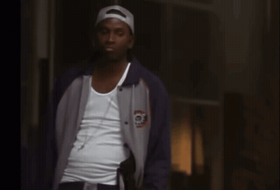 Man Talking On Cell Phone Behind Fence GIF