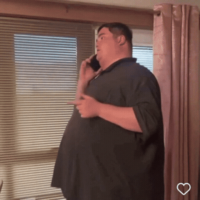 Man Talking On Cell Phone By Window GIF