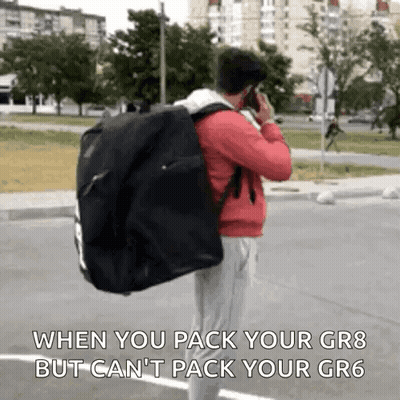Man Talking On Cell Phone Carrying Bag GIF