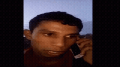 Man Talking On Cell Phone Covering Ears GIF