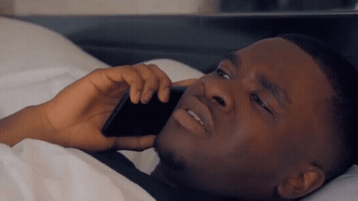Man Talking On Cell Phone In Bed GIF