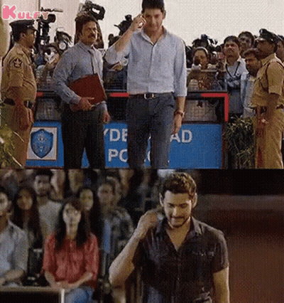 Man Talking On Cell Phone In Front Of Crowd GIF
