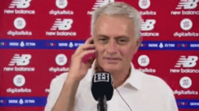 Man Talking On Cell Phone In Front Of New Balance Sign GIF