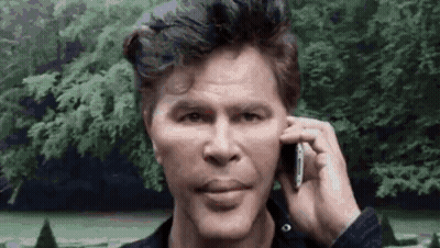 Man Talking On Cell Phone In Front Of Trees GIF