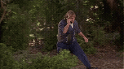 Man Talking On Cell Phone Leaning Against Tree Branch GIF