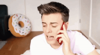 Man Talking On Cell Phone With Doughnut Pillow GIF