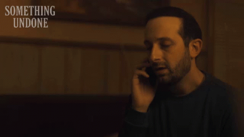 Man Talking On Cell Phone With Something Undone GIF