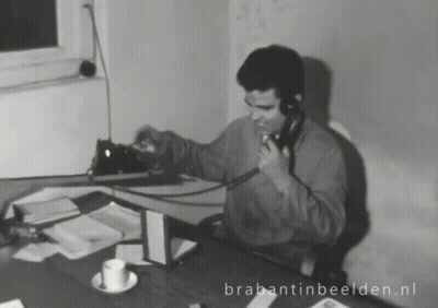 Man Talking On Phone At Desk Brabantinbeelden.nl GIF