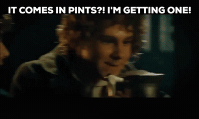Man Talking To Another Man Holding Coffee In Dark Room GIF