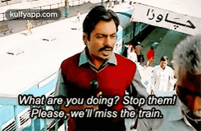 Man Talking To Another Man On Train Platform Holding Microphone GIF