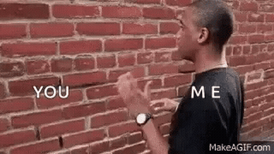 Man Talking To Himself At Brick Wall GIF