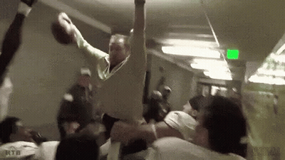 Man Throwing Football While Crowd Watches GIF