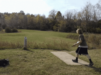 Man Throwing Frisbee In Grassy Field GIF