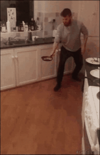 Man Throwing Frying Pan In Kitchen GIF