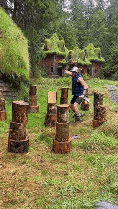Man Throws Log In Field GIF