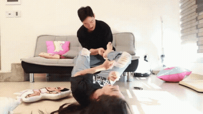 Man Tickling Girl Laying On Floor GIF