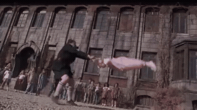 Man Tossing Girl In Front Of Building GIF