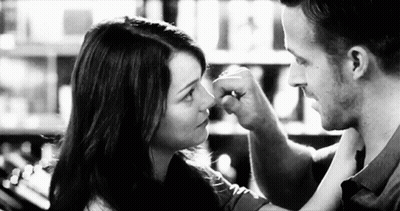 Man Touching Woman Nose With Fist GIF