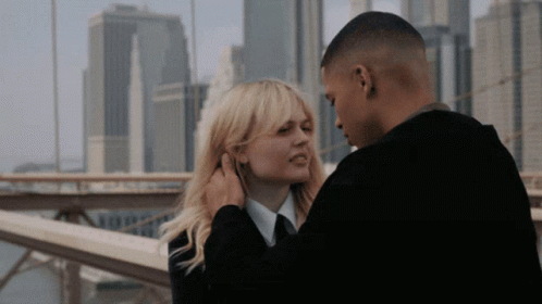 Man Touching Woman's Ear GIF