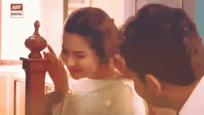 Man Touching Woman's Face In Front Of Ary Digital Sign GIF