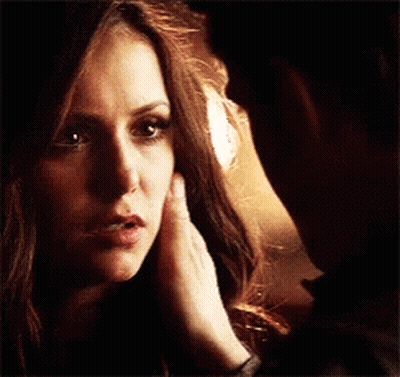 Man Touching Woman's Face While Looking At Each Other GIF