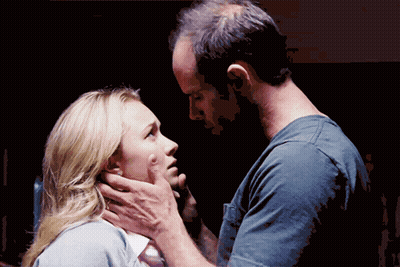 Man Touching Woman's Face While She Looks At Him GIF
