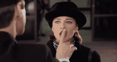 Man Touching Woman's Nose Wearing Hat GIF